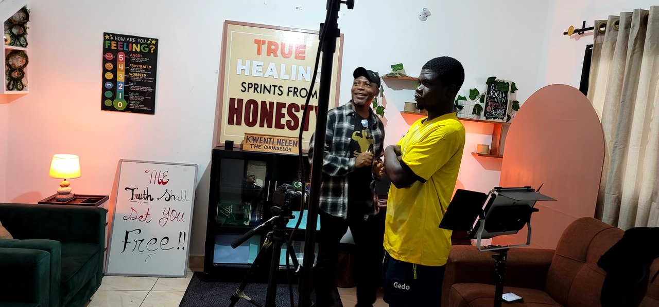 A production crew coordinates a shoot on an interior set.