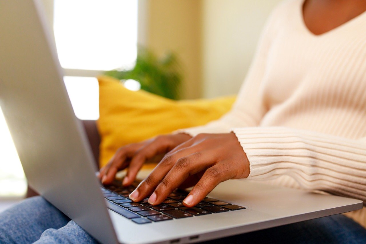 A writer typing on a laptop.