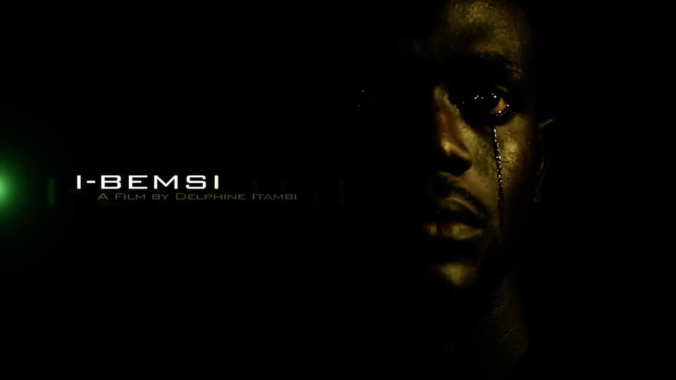 The I-Bemsi title card, with the film name in warm gold beside a face in shadow.
