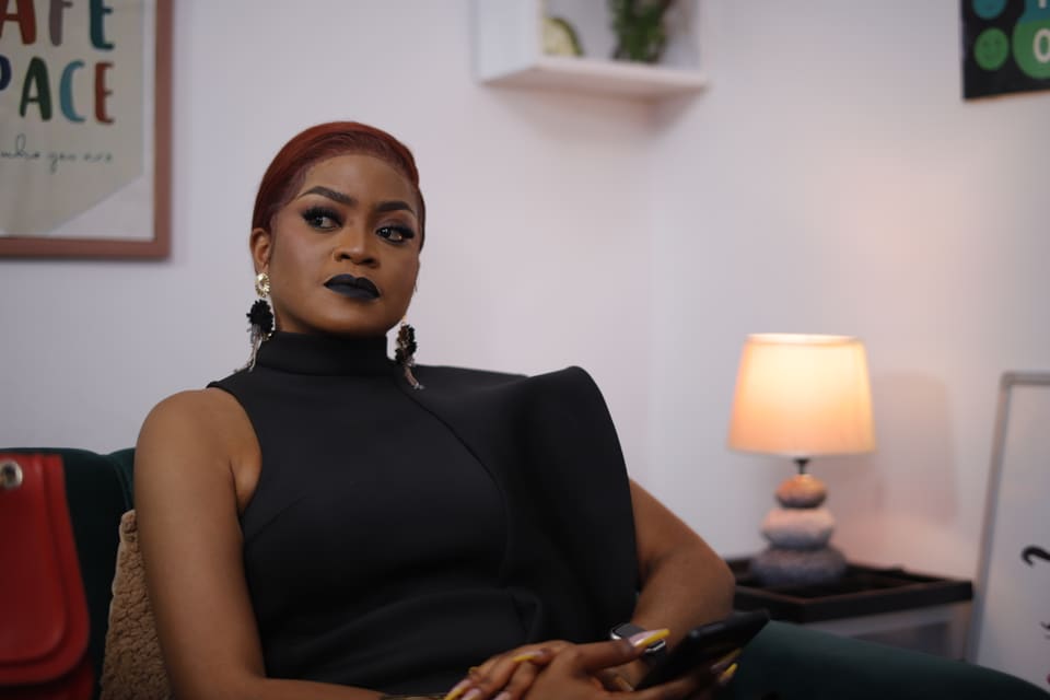 A seated creative professional inside an Itambi Studios office setting.